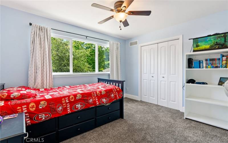 Bedroom 4 offers plush carpet and a ceiling fan.