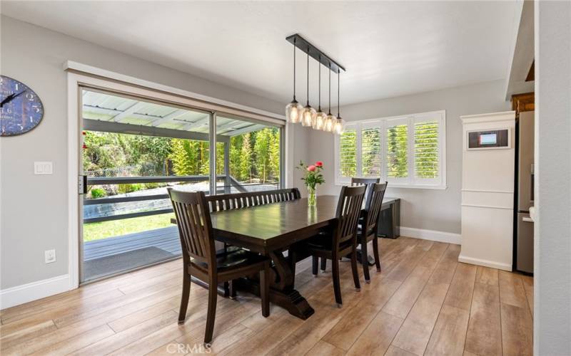 The dining area is brightened by the large sliding glass door that leads out a covered deck and back yard.
