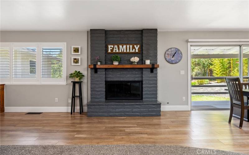The focal point of the living room is the handsome wood burning fireplace with brick surround.