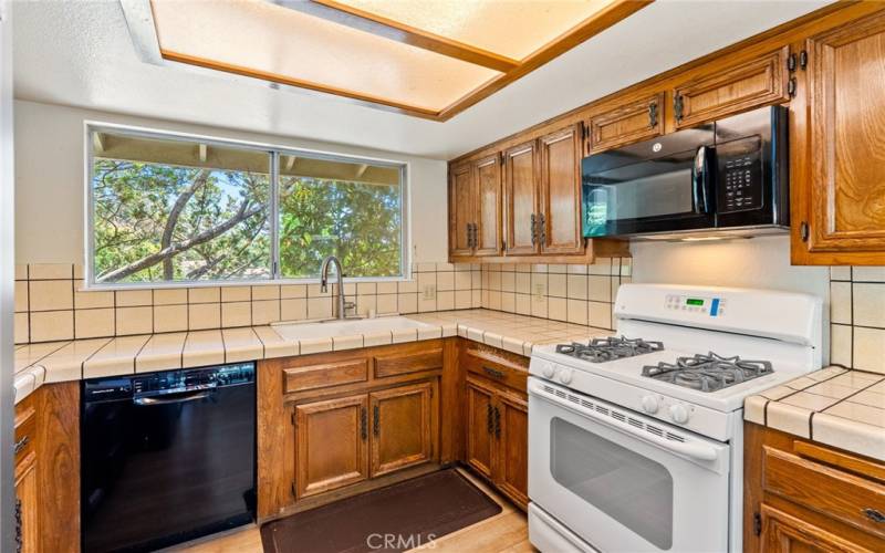 The kitchen provides ample cabinet and countertop space for preparing meals.