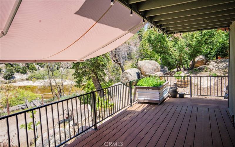 Manual awning offers ample shade over deck