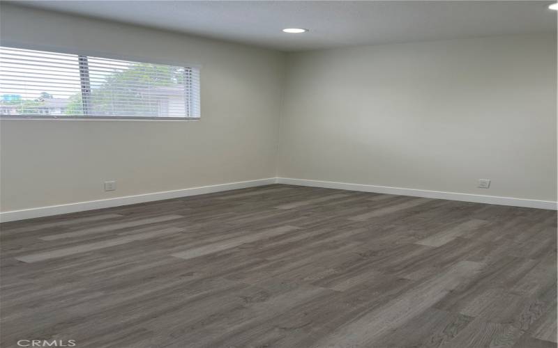 Bedroom #1 with new luxury vinyl flooring, blinds, and baseboards.