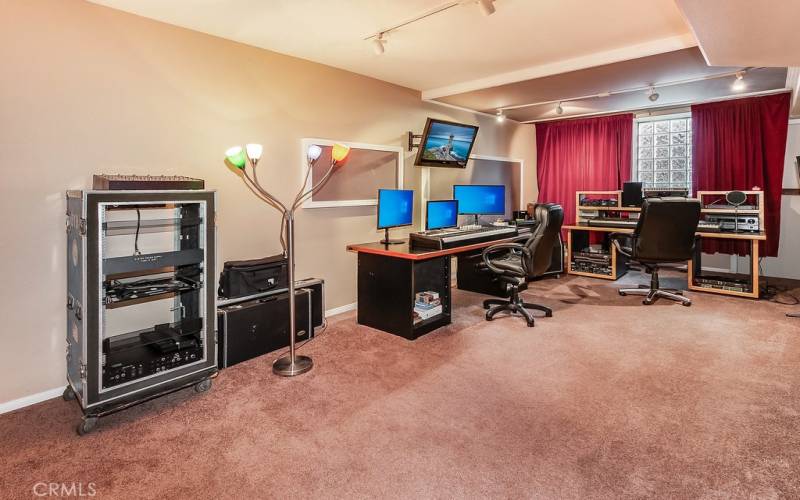 PROFESSIONAL MUSIC STUDIO with private entrance, track lighting, machine room, storage closet and plush carpet.