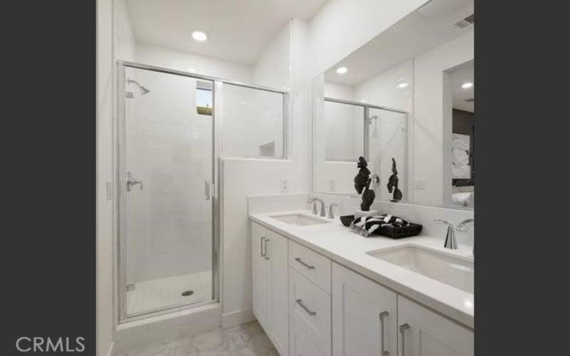 The large walk-in shower includes a full-height tile surround