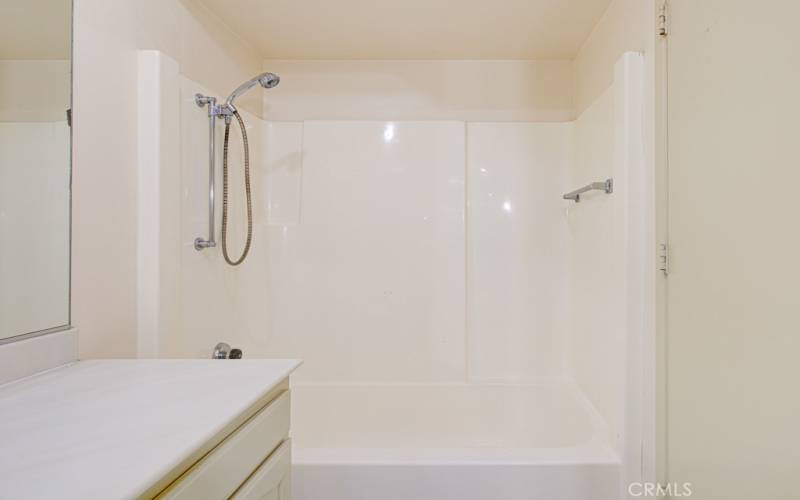 Shower/tub combo in left side bathroom.