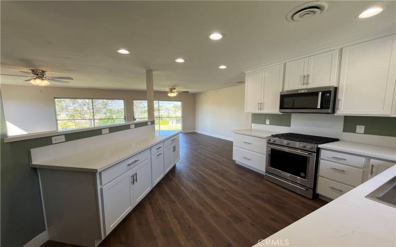 Another kitchen to family room view.  Lots of counter space!  Ceiling fans to keep you cool.
