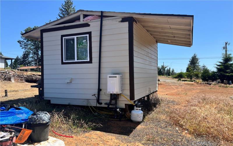 Shed with tankless hot water heater