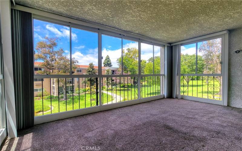 Enclosed balcony adds more square footage and has great views of the neighborhood.