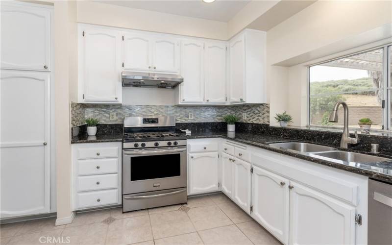 Brand new range stove in the kitchen with other stainless steel appliances.