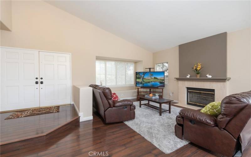 Upon entering you will see high vaulted ceiling and gleaming laminate flooring in the spacious living room with beautiful fireplace.