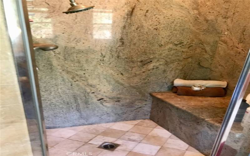 Primary shower is also granite and travertine