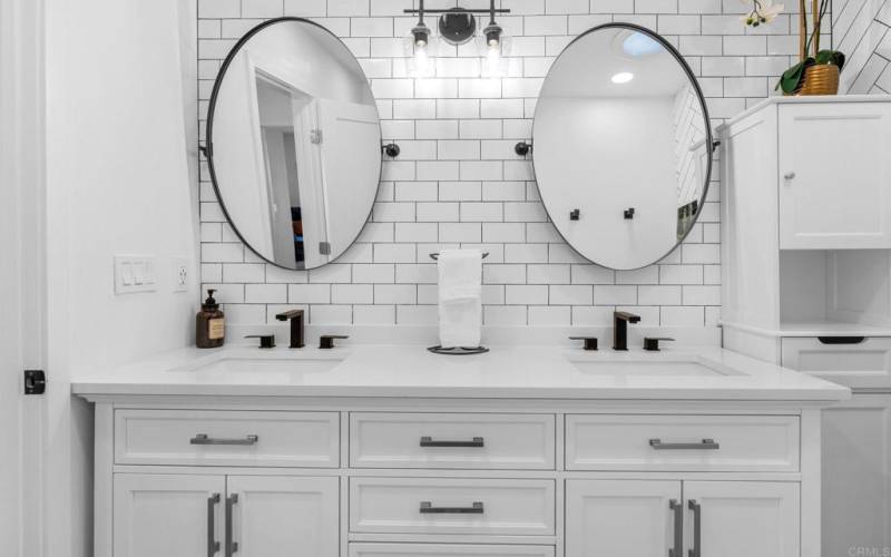 Hall Bath has exceptional cabinetry, mirrors, lighting and back splash