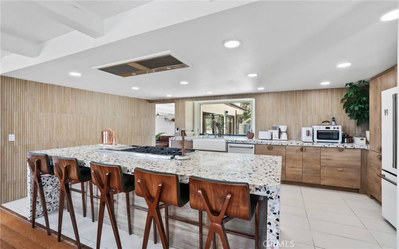 Entertainers kitchen features Concrete Collaborative Counters and Wall tiles.