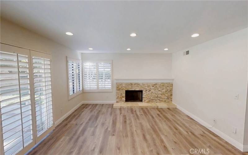 family room showing plantations shutters and recessed lights