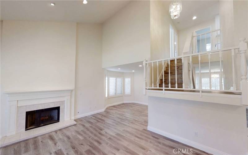 Living room that leads into formal dining room with bay window