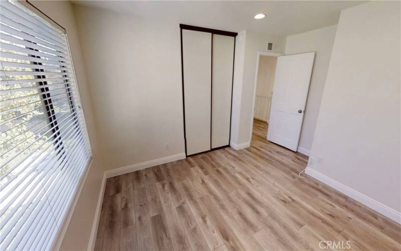 upstairs bedroom with recessed lights and closet organizers