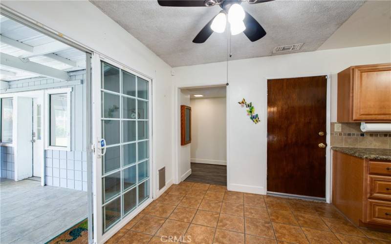 Dine in area with hall to bonus room and patio door to back yard.