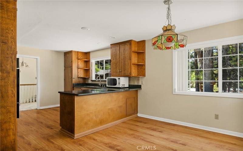 Kitchen with granite counter tops and open to dining area.