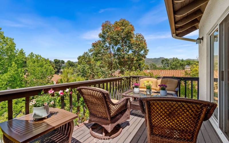 Step onto the beautiful balcony overlooking the lush landscape, trees, golf course views