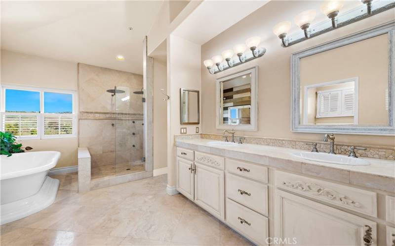 Primary bathroom. Walk in shower w 2 shower heads and beautiful tub.