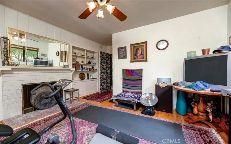 Exercise/rec room with fireplace.