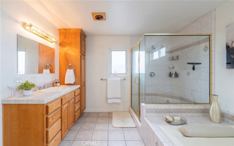 Spacious primary bathroom with separate shower and soaking tub.