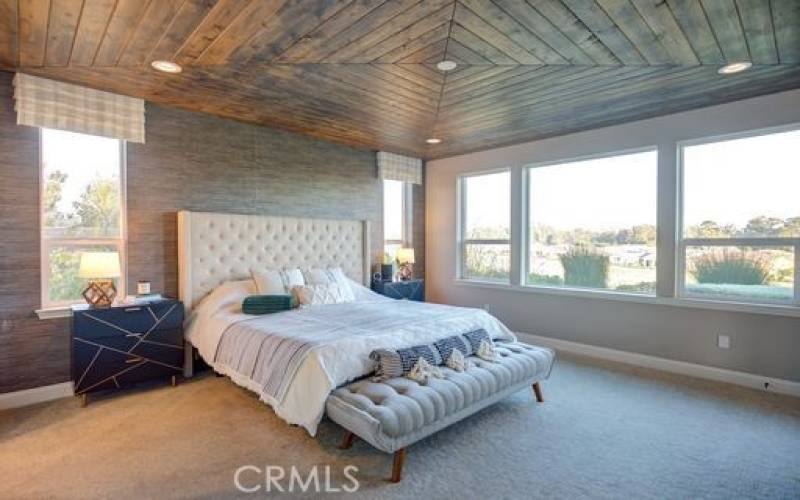Master Bedroom with accent wall and custom wood ceiling.
