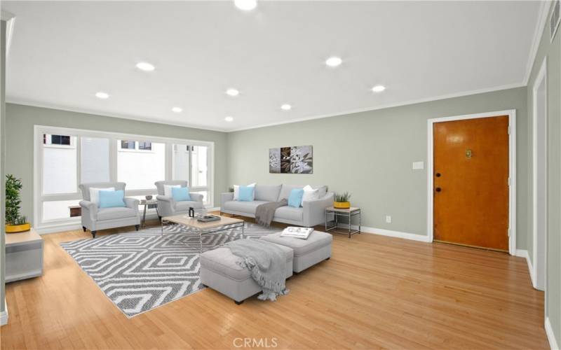 Expansive living room with gleaming hardwood floors, new windows and recessed lighting. Virtually Staged