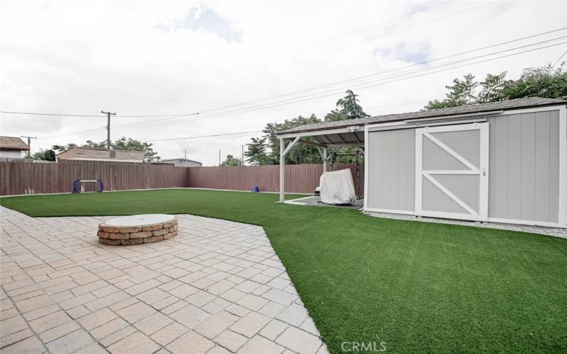 Back yard easy maintenance with artificial turf and pavers