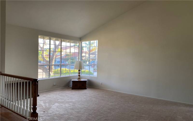 Massive Formal Living room with 2 story vaulted ceilings is very light and bright with ample windows.