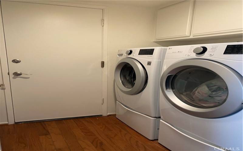 Separate laundry room with ample storage located downstairs.