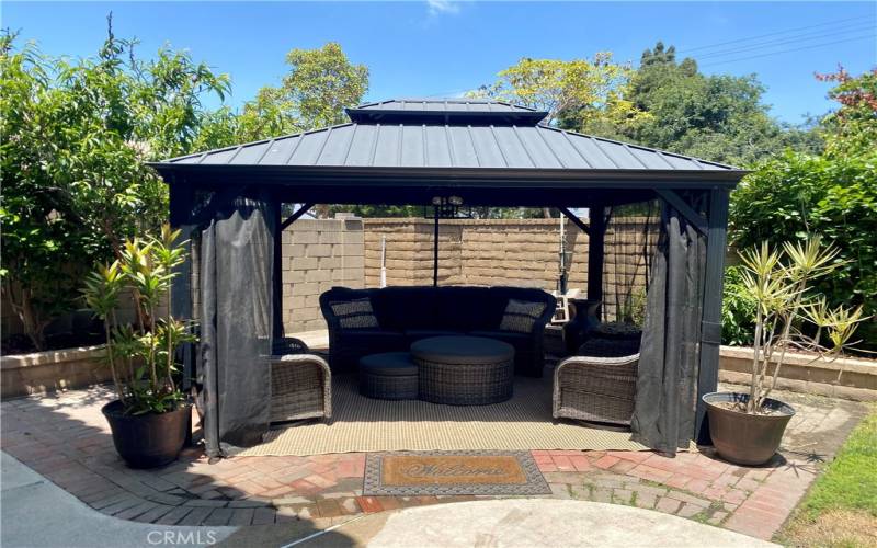 Relaxing pergola in the backyard is included.