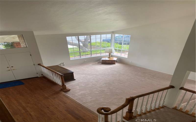 View of the formal living room and entry from the upstairs.