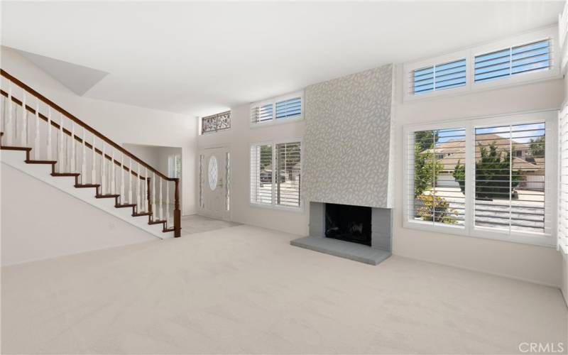 light filled living room area with designer fireplace tile