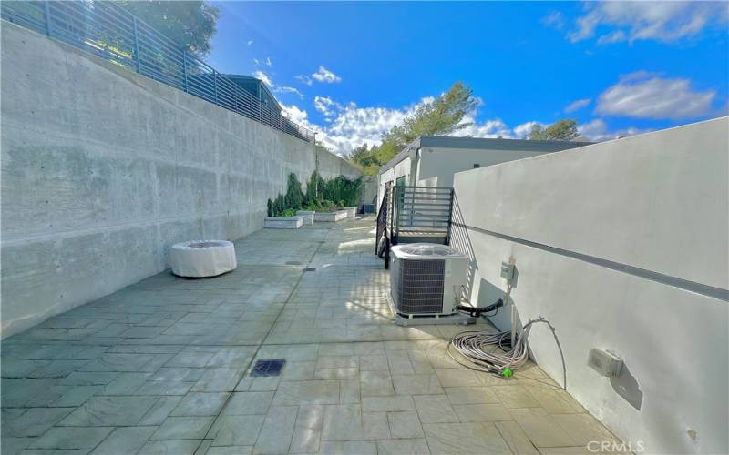 Private Backyard with Stairs to Rooftop Deck and A/C