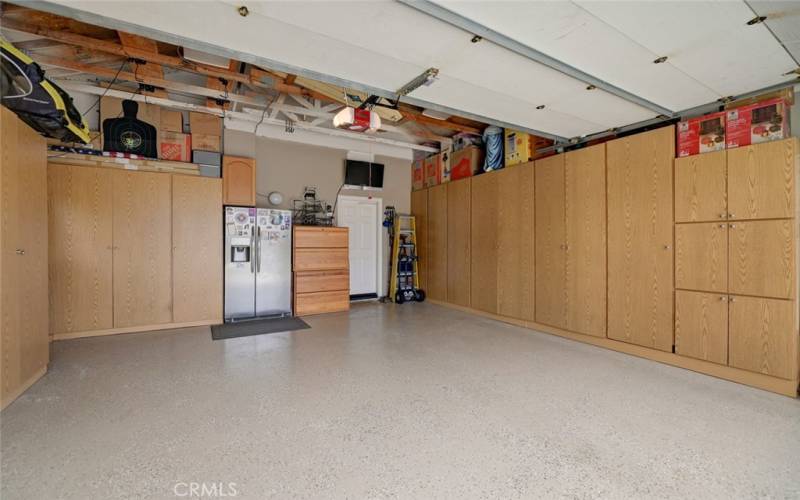 Garage with epoxy floor, built in cabinets and overhead storage