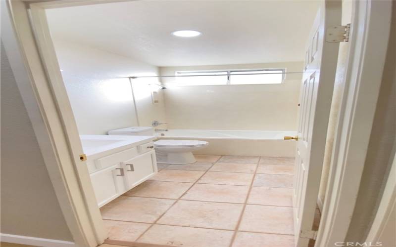 Hallway full bath with shower and tub