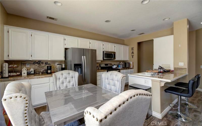 The kitchen area with the cool bar and barstools!