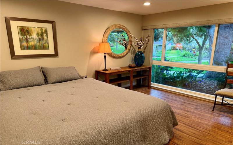 Master Bedroom with Large Window for Viewing the Lush Greenbelt Area.
