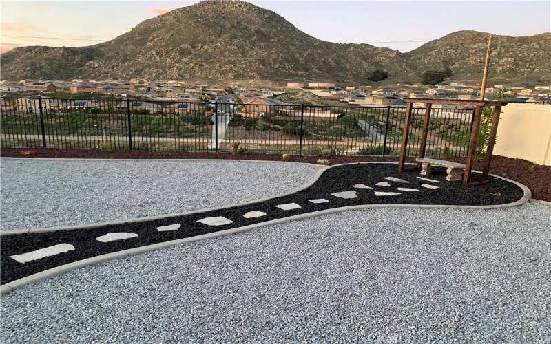 Rear Yard with complete landscape with rocks and drought tolerant plants of other area with mountain view.