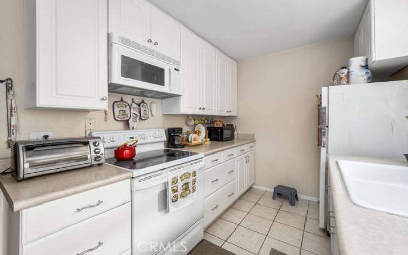White cabinets, easy-to maintain countertop.