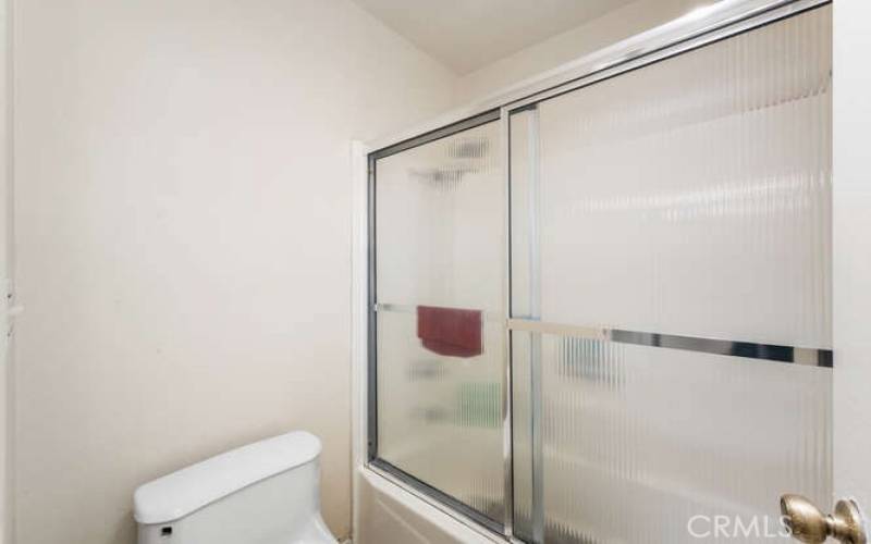 Shower -in-tub with sliding door.