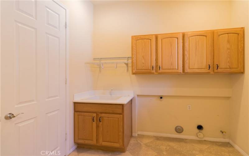 Laundry with pantry and deep sink.