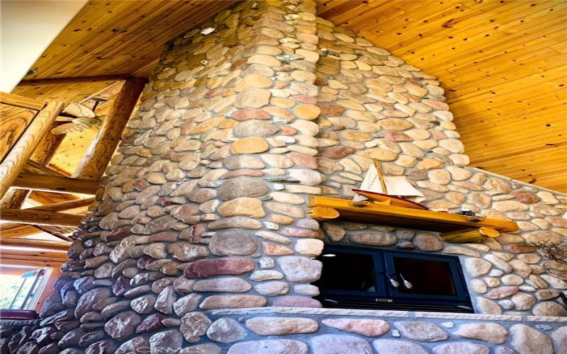 Floor to ceiling rock fireplace..