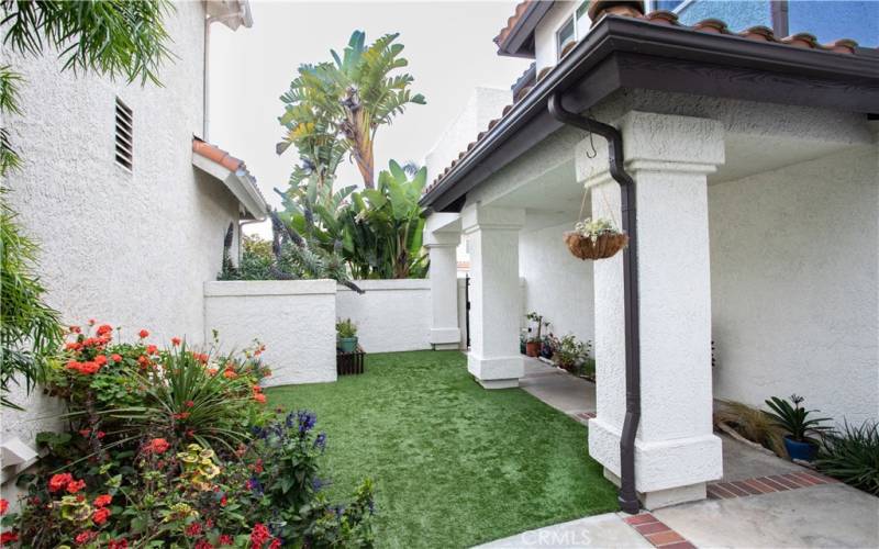 Faux grass in front and side yards, maintenance free and always green!