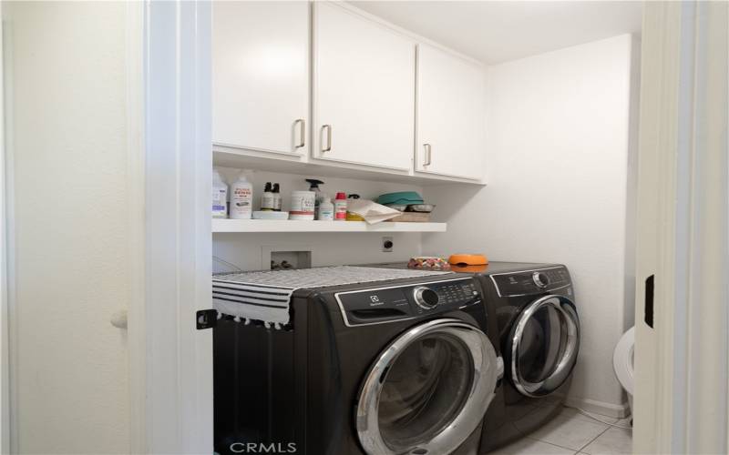 Dedicated laundry room with sink and tons of storage.