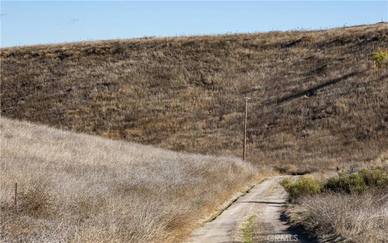 View from Road in front for Property looking towards Corner of Landmark Pl. and Rolling Hills Wy.