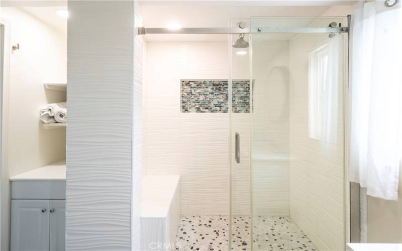 Primary Bathroom with Tile Shower, Bench, Glass Doors and Rainfall Showerhead