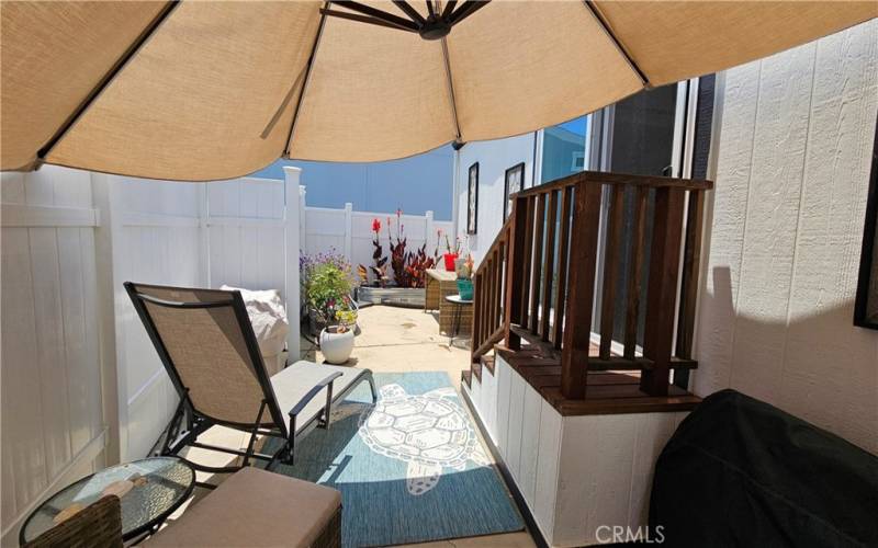 Beautiful patio off of Primary Bedroom with large umbrella & firepit