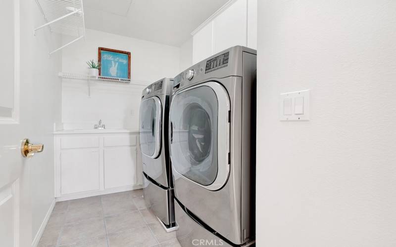 LARGE upstairs laundry room with utility sink!